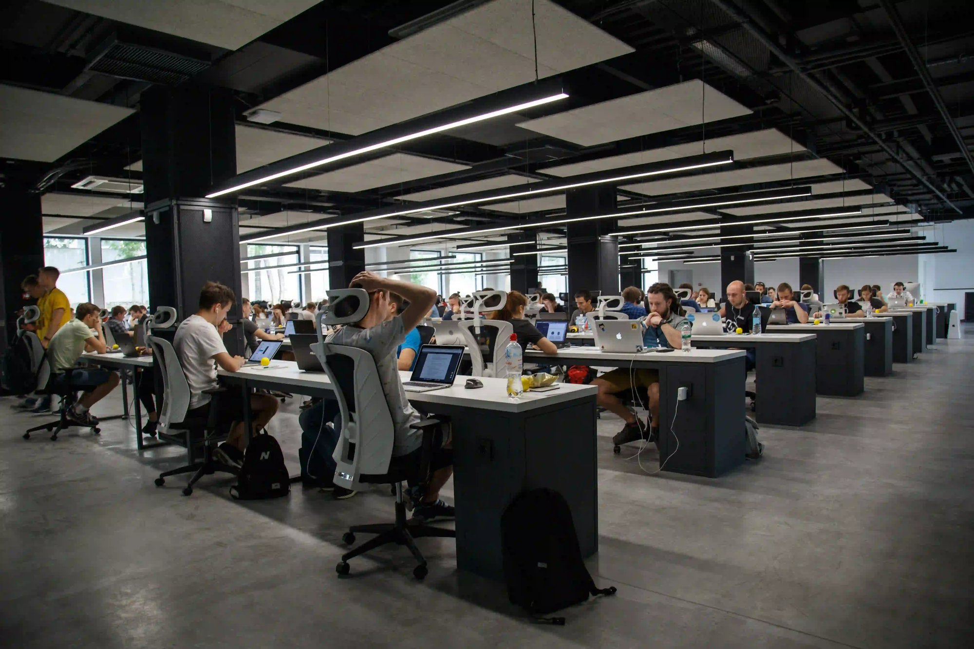 Open-plan tech office with team working collaboratively, representing Gradion’s global cloud and security expertise.