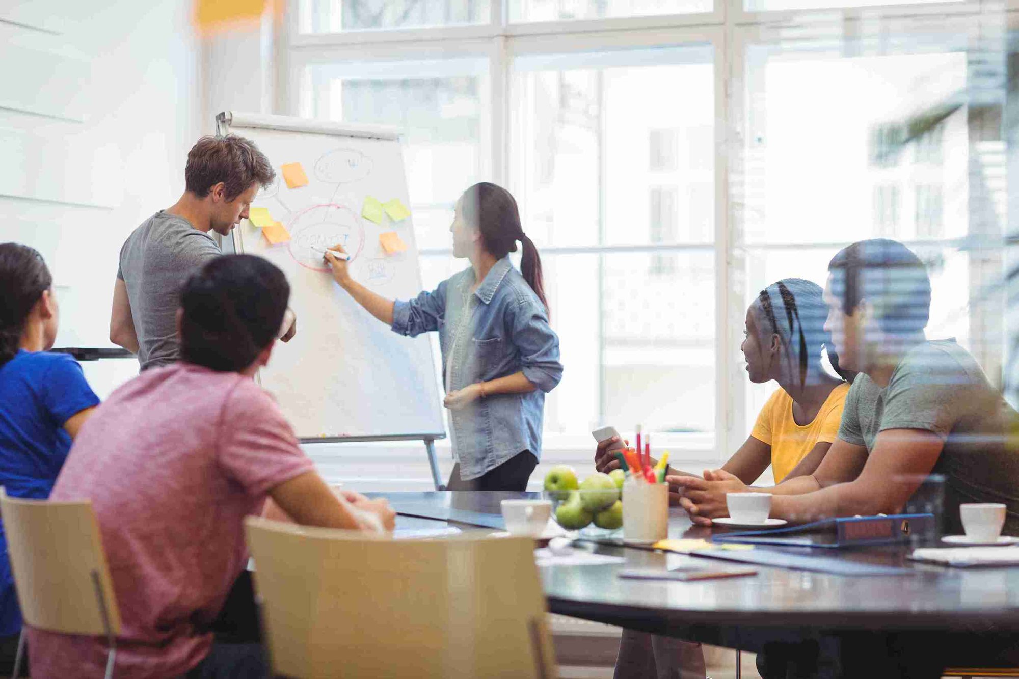 business-executives-discussing-with-their-colleagues-whiteboa_1_11zon