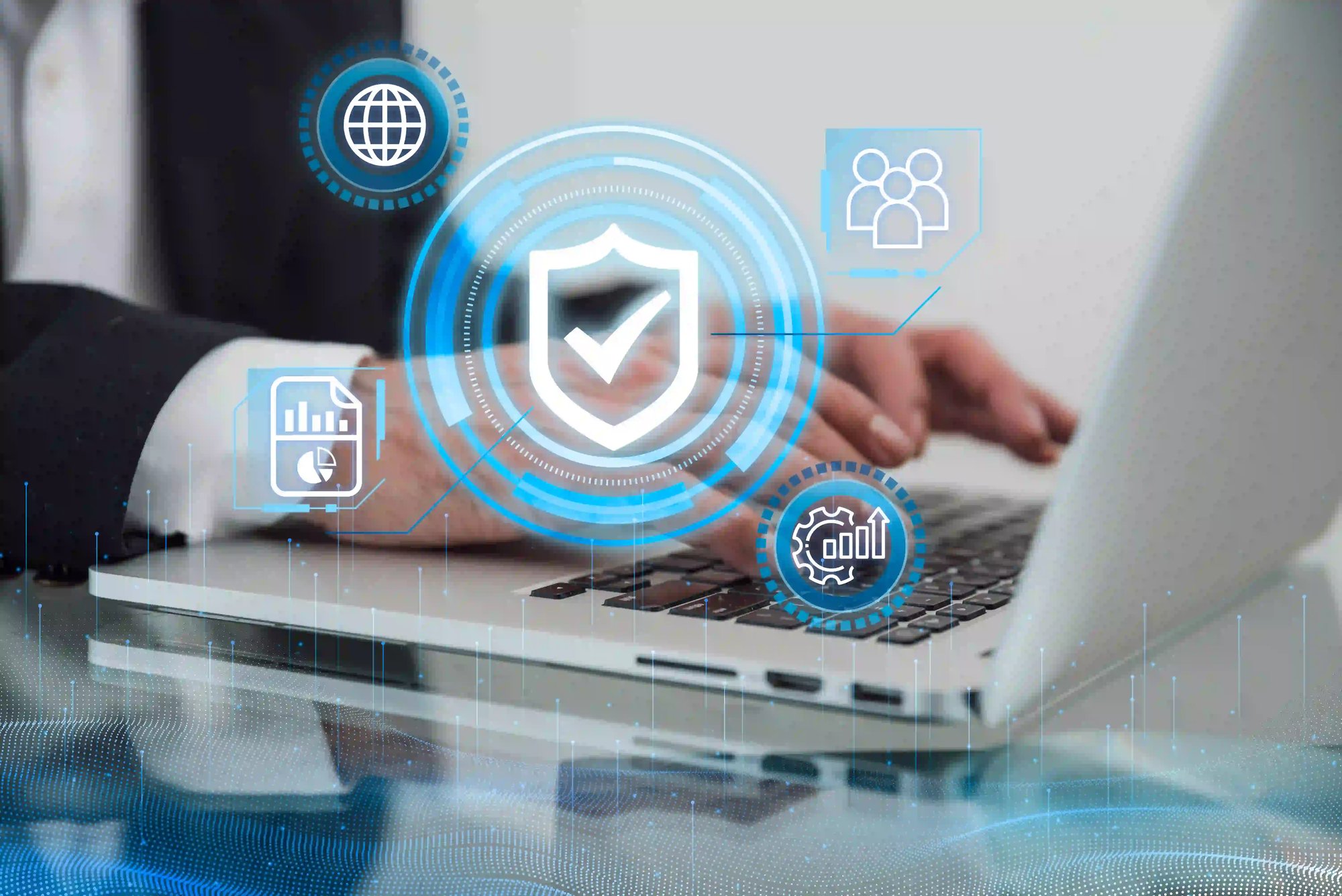 Hands typing on laptop with holographic cybersecurity shield and data icons.